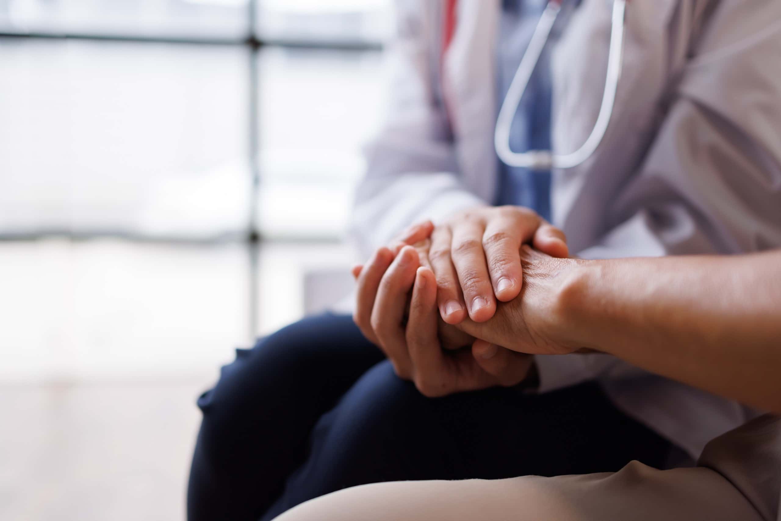 A Carenet Health clinician holding a patient's hands